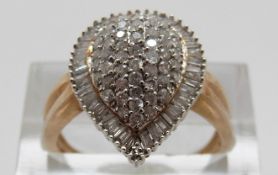 A 9ct gold ring set with round cut diamonds within a border of baguette cut diamonds in a pear