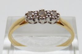 An 18ct gold ring set with three diamonds, size W,