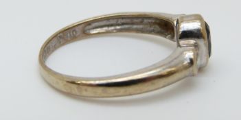 A 9ct white gold ring set with an oval sapphire of approximately 0.4ct and two diamonds, size L, 2.