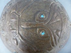 A late 19th/20thC Arts & Crafts or Eastern hammered plaque, the central figure with phallic nose,