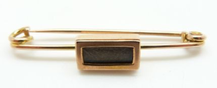 A 9ct rose gold mourning brooch with a rectangular section set with plaited hair