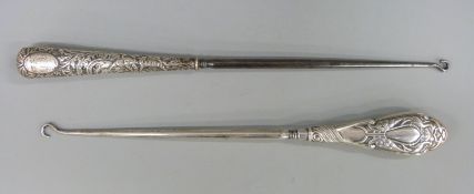 Two long hallmarked silver handled button hooks,