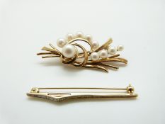 A 9ct gold brooch in a stylised foliate design set with pearls and a 9ct gold brooch set with