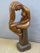 A carved wooden female figure,