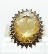An 18ct gold ring set with a citrine and diamonds, size Q/R, 8.