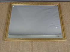 A large gilt framed mirror with bevelled edge,