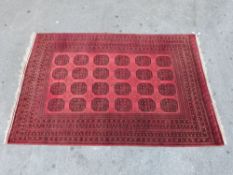 An Afghan red ground rug,