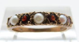 A 9ct gold ring set with garnets and pearls, size O, 2.