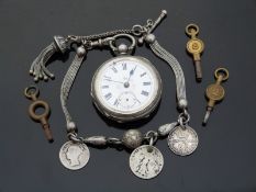 A white metal cased ladies fob watch with floral decoration to the white enamel dial,