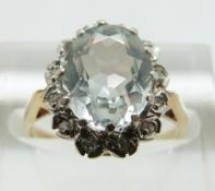 A 9ct gold ring set with an oval aquamarine surrounded by diamonds, size L/M, 2.