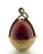 A Russian enamel egg pendant in a red enamel basket, marked 84,