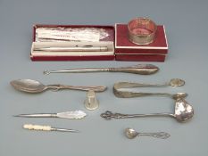 A hallmarked silver spoon, silver sugar tongs, silver ladle,