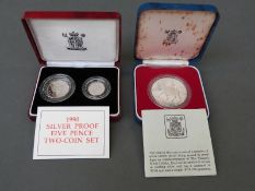 A cased 1990 silver proof five pence coin set and a 1977 Queen Elizabeth II Silver Jubilee silver