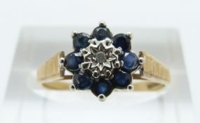 A 9ct gold ring set with a diamond and sapphires