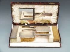 A cased hallmarked silver five piece dressing table set,