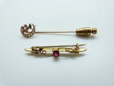 A 14ct gold stick pin set with seed pearls and enamel in the form of a crescent and flower and a