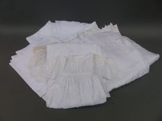 A collection of linen and lace to include tablecloths,