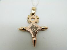 A yellow metal cross pendant with unusual filigree detail to the centre, 5.