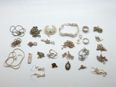 A collection of silver jewellery to include filigree brooch, chains,