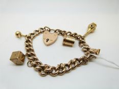 A 9ct gold charm bracelet with 9ct gold charms including tankard, dice,