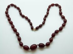 A graduated cherry amber bead necklace, 29.