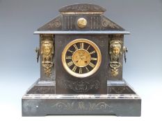 A large French 19thC two-train slate mantel clock with visible escapement.