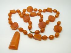 An amber necklace of 40 butterscotch coloured beads of varying shapes, largest approximately 22x9mm,