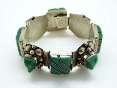 A Mexican sterling silver bracelet c1965 set with green onyx Mayan masks
