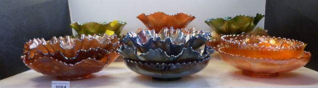 Twenty pieces of Carnival glass including Dragon and Lotus, Peacock and Grapes, Windmill pattern,