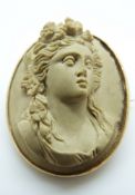 A 9ct gold brooch set with a lava cameo of a young women