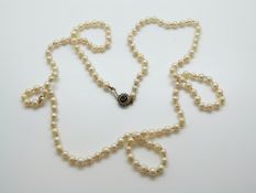 A single strand of cultured pearls with silver clasp