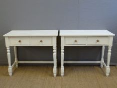 A pair of painted pine two drawer side tables,