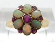 An 18ct gold ring set with opals and rubies, size M, 1.