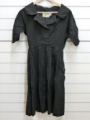 A 1950's black twill dress by fredrica, Starke of London,