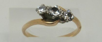 An 18ct gold ring set with three diamonds in a platinum twist setting,
