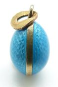 A silver Russian enamel egg pendant set with aqua coloured guilloché enamel, possibly marked 9ct,