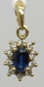 A 9ct gold pendant set with a sapphire and diamonds