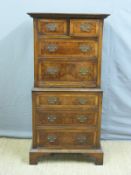 A small walnut chest on chest with brushing slide,