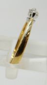 An 18ct gold ring set with a diamond of approximately 0.