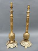 A pair of ornate brass table lamps,