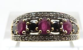 A 9ct gold ring set with black diamonds and rubies, size P, 3.