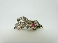 A Victorian brooch set with old cut and rose cut diamonds, a ruby cabochon and emeralds,