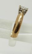 An 9ct gold ring set with a round cut diamond of approximately 0.2ct, 2.