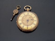 An 18k yellow metal cased ladies fob watch with engraved foliate decoration, marked to case 18k,
