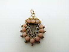 A Victorian pendant set with coral cabochons and seed pearls