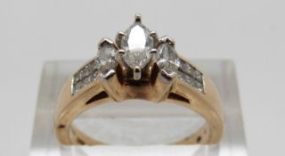 A 14ct gold ring set with three marquise cut diamonds and further square cut diamonds, size M, 5.