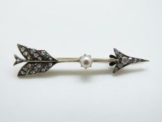 A Victorian brooch set with old cut diamonds and a pearl in the form of an arrow