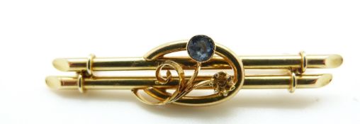 A 15ct gold brooch set with a sapphire, 3.