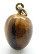 A Russian tiger's eye egg pendant with gold loop marked 9ct, L13.