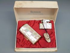 A boxed Ronson lighter set with tiled mother of pearl decoration and matching cigarette case,